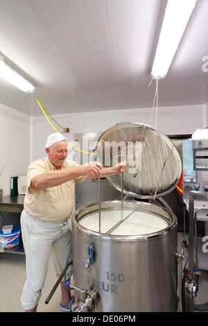 Cheesemaker during the production of goat cheese at the Goas-Alm cheese factory Stock Photo