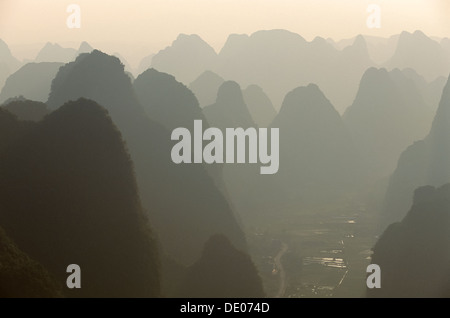 Looking down onto the cluttered limestone peaks and paddy fields, from Pantao Shan hill at sunset, Yangshuo, near Guilin, Guangxi, China Stock Photo