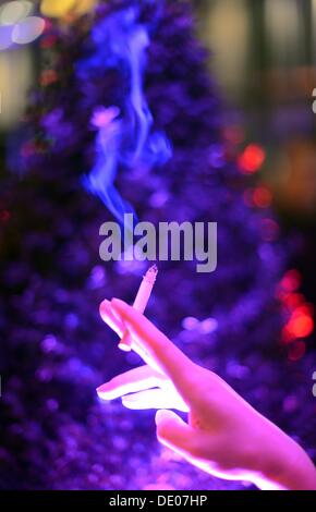 Berlin, Germany. 05th Sep, 2013. A woman holds a cigarette in her hand at the event 'Music meets Media' at Grand Hotel Esplanade in Berlin, Germany, 05 September 2013. Photo: Jens Kalaene/dpa/Alamy Live News Stock Photo