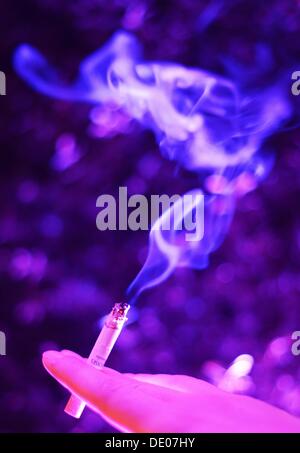 Berlin, Germany. 05th Sep, 2013. A woman holds a cigarette in her hand at the event 'Music meets Media' at Grand Hotel Esplanade in Berlin, Germany, 05 September 2013. Photo: Jens Kalaene/dpa/Alamy Live News Stock Photo