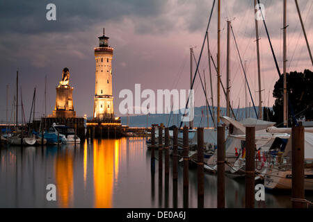 Lighthouse and the Bavarian lion, symbol of the city, at the harbour entrance of Lindau on Lake Constance, Bavaria Stock Photo