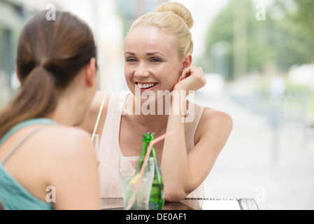 Women chatting at sidewalk cafe Stock Photo