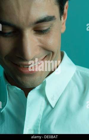 Man smiling, looking down, close-up Stock Photo