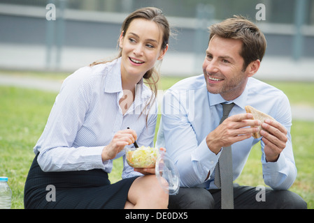 Coworkers having lunch together outdoors Stock Photo