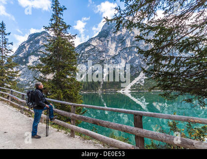 56-year-old hikers enjoying the view on lake Pragser Wildsee, lake Lago di Braies, Pragser Tal valley, Prags, Dolomites Stock Photo