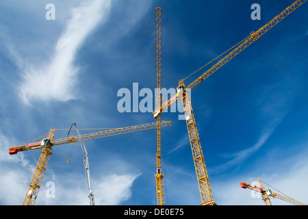 Construction cranes against blue sky Stock Photo