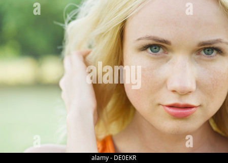 Young woman with hand in hair, portrait Stock Photo