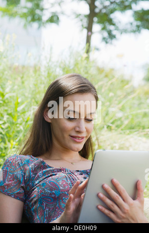 Woman using digital tablet outdoors Stock Photo