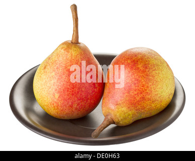 Two ripe pears on a black plate on a white background Stock Photo
