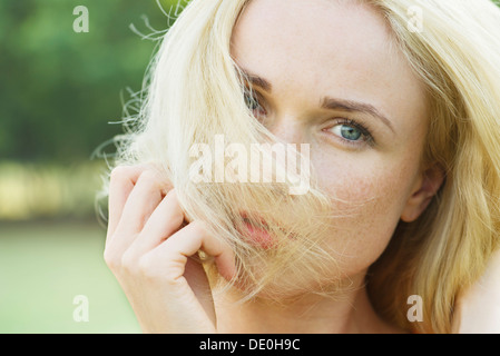Woman covering face with hair, portrait Stock Photo