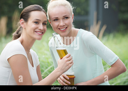 Women drinking beer together Stock Photo