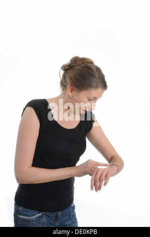 Young woman looking at her wristwatch Stock Photo