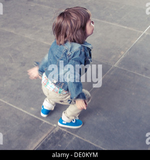 Boy jumping outdoors Stock Photo