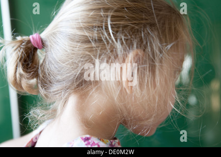 Girl with messy ponytail, side view Stock Photo