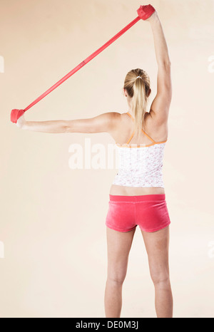Young woman doing exercises with a Theraband Stock Photo