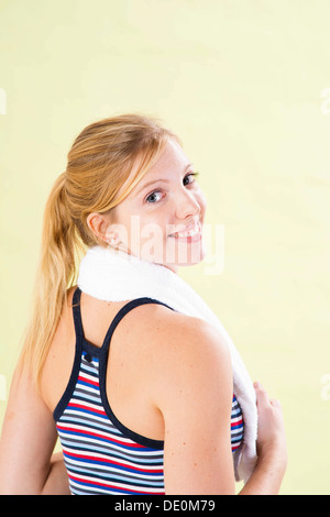 Smiling young woman after doing sport Stock Photo