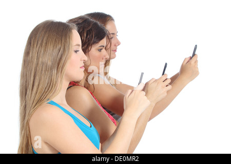 Group of teenager girls obsessed with the smart phone isolated on a white background Stock Photo