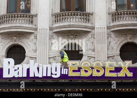 Man fixing the Barking Essex sign on the Wyndham's Theater in London The Hilarious New Comedy By Clive Exton Stock Photo