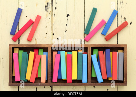 colorful crayons in a box on wooden table Stock Photo