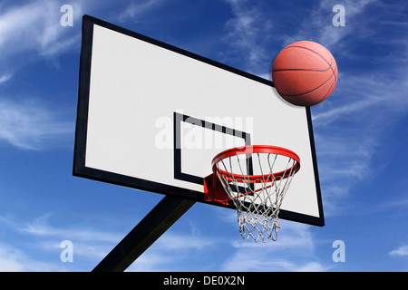 a basketball and a panel of basketball on a background of blue sky