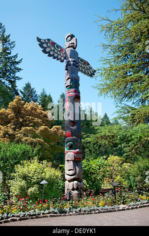 Aboriginal Totem Pole stands in the Butchart Gardens. Stock Photo
