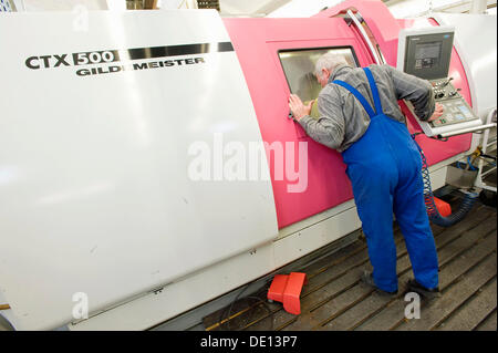 Lathe operator using a CNC Gildemeister turning lathe, prefabrication, Krones AG Rosenheim plant, production of packaging Stock Photo