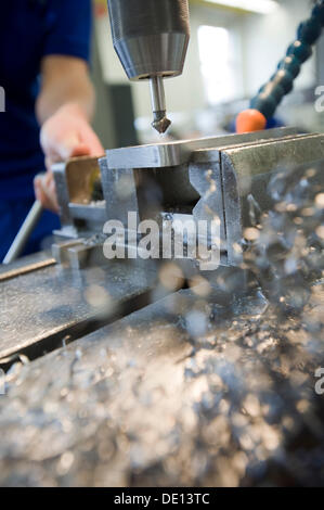 Countersink drilling with a drill press during the apprenticeship for a mechatronics engineer Stock Photo