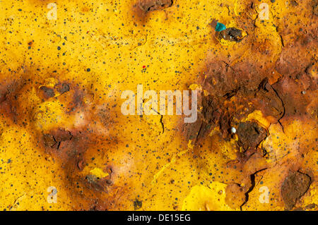 Metal surface with rust and remains of yellow paint Stock Photo