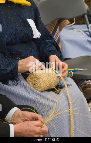 Hands of a woman in traditional costume at work at the Santa Eulalia yearly traditional handicrafts fair, Santa Eulalia, Ibiza Stock Photo