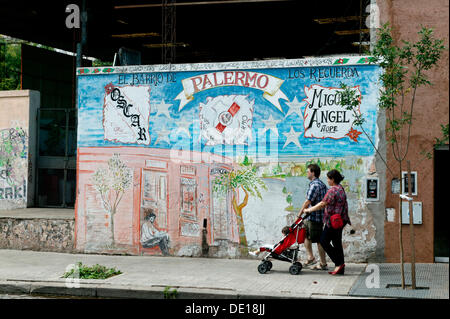 Family passing painted house, Palermo Viejo district, Buenos Aires, Argentina, South America Stock Photo