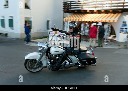 Sils Maria, Switzerland, motorcyclist on his Harley -Davidson in the village Stock Photo