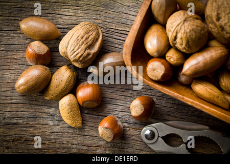the various unpeeled nuts in wooden bowl Stock Photo