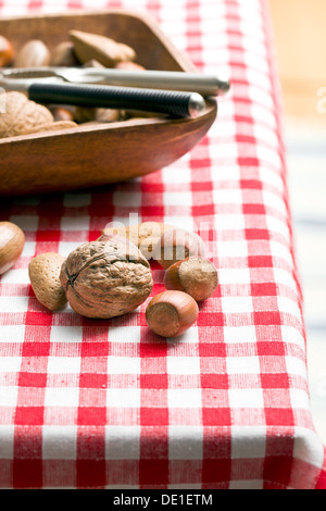 various unpeeled nuts on table Stock Photo