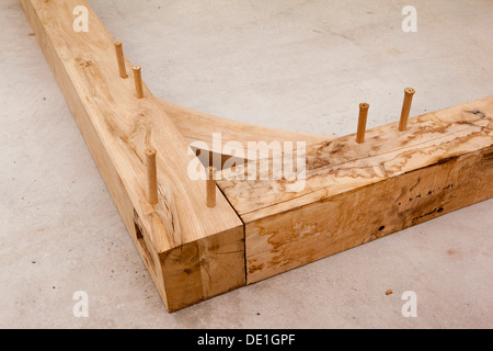 self building house, constructing green oak timber framed structure, pegged mortice and tenon joint and bracing Stock Photo