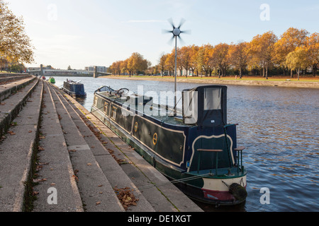 Narrowboat with wind generator. Boat using a wind turbine for power while moored on the River Trent, Nottinghamshire, England, UK Stock Photo