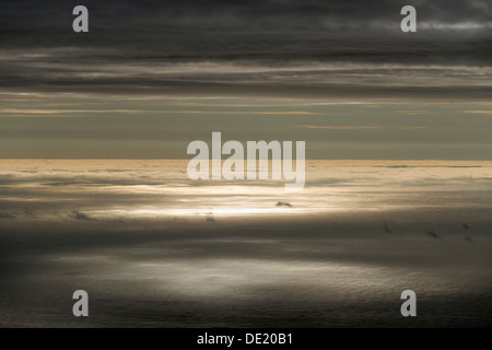 Sun reflecting on the surface of the sea, clouds, Eysturoy, Faroe Islands, Denmark Stock Photo