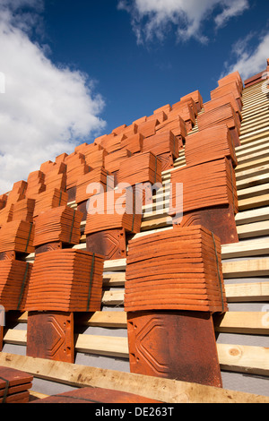 self building house, roofing, piles of traditional clay roof tiles stacked on laths ready for laying Stock Photo