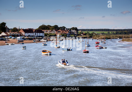 Boaters entering the safe harbour at Burnham Overy Staithe, near Burnham Market, Norfolk Stock Photo