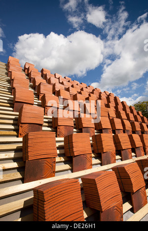 self building house, roofing, piles of traditional clay roof tiles stacked on laths ready for laying Stock Photo