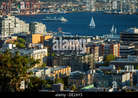 Ferry and Sailboats in the Puget Sound with buildings of Seattle Washington, USA Stock Photo