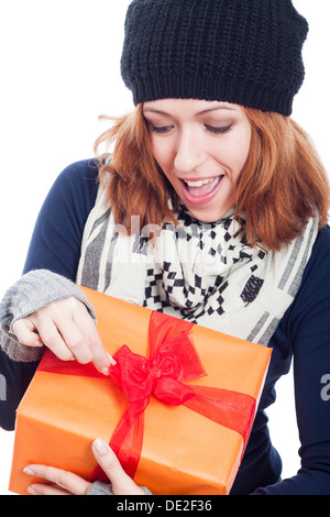 Closeup of exited winter woman opening present. Stock Photo