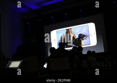 Berlin, Germany. 10th Sep, 2013. Journalists watch the presentation of the new iPhone 5S on a large video screen at the Apple Store in Berlin, Germany, 10 September 2013. The introduction of the new Apple smartphones took place in Cupertino, California. Photo: Kay Nietfeld/dpa/Alamy Live News Stock Photo