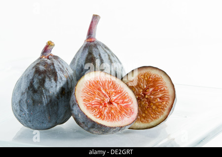 mission figs served on a glass plate isolate don a white background Stock Photo