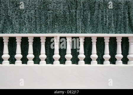 A white stone balustrade in front of an artificial green hedge, Menorca, Balearic Islands, Spain, Europe Stock Photo