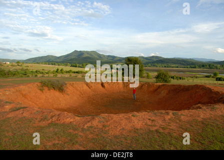 Large bomb crater from the Vietnam War, Ban Khai, landscape at Phonsavan, Xieng Khouang province, Laos, Southeast Asia, Asia Stock Photo