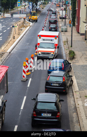 Ambulance for a trip alarm with flashing lights and sirens. Moves to an inner-city site against the direction of traffic. Stock Photo