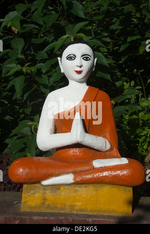 Theravada Buddhism, meditation, figure of a praying monk at a temple, Octagonal Pavilion of Jingzhen, near Menghai in Jinghong, Stock Photo