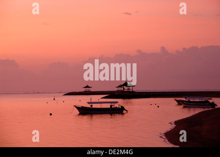 Pink-colored sunrise, boats in silhouette, beach of Sanur, Bali, Indonesia, Southeast Asia, Asia Stock Photo