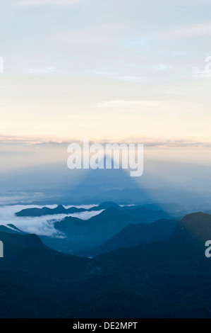 Pilgrim mountain, sun creating a triangle shadow in the landscape, image of God, Buddhist temple, Adam's Peak, Sri Pada Stock Photo