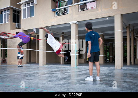 Men playing takraw in a housing estate, Penang, Malaysia Stock Photo